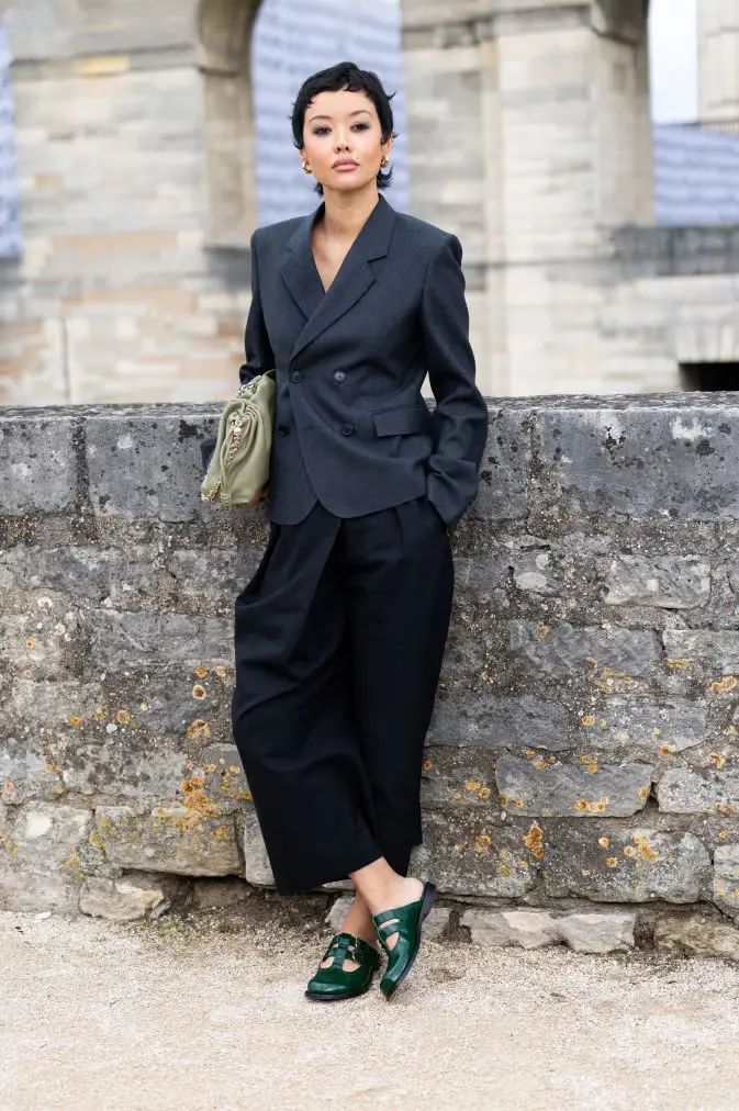 guest wears gold hoop earrings a light green leather pouch news photo 1729864314